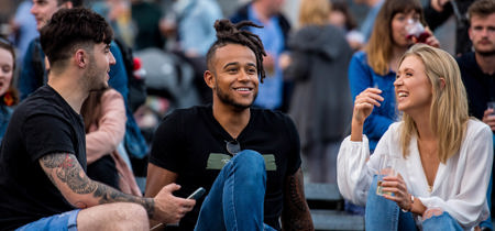 Stock photo of 2 males and 1 female having a discussion 