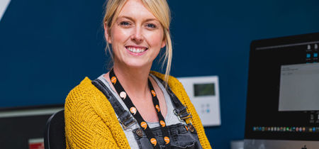 Woman working in an office smiling 