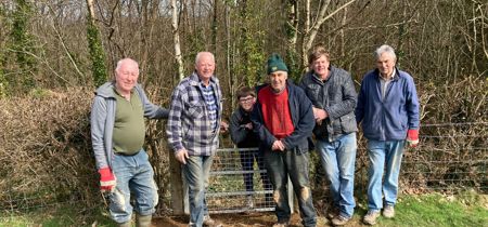 Volunteers from Ramblers Cymru standing in a field 