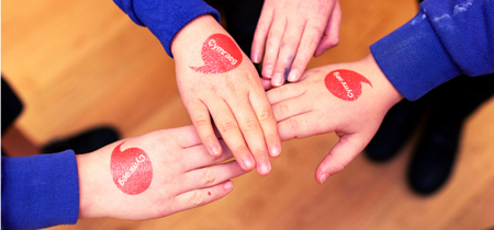 Iaith Gwaith logo on hands 