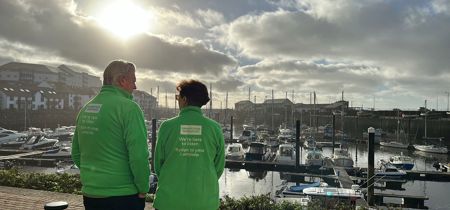 Samaritans volunteers standing by boats 