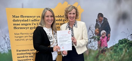 Welsh Language Commissioner presenting the Cynnig Cymraeg certificate to the WWF 